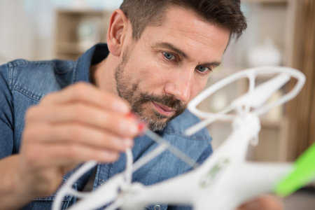 man fixing a crashed drone