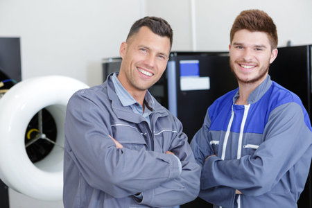 portrait of electrician with apprentice