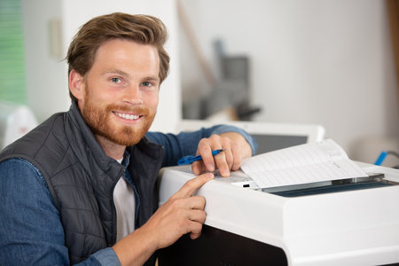 happy male technician installing air-conditioning systemの写真素材