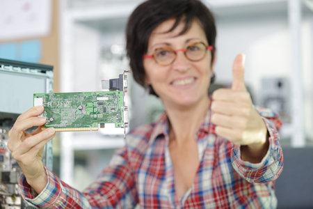 happy female technician showing thumb upの写真素材