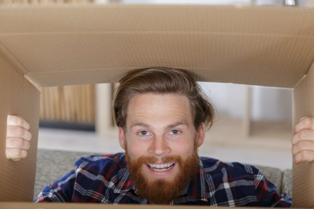 happy man looking into a boxの写真素材