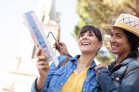 young happy tourists sightseeing in cityの写真素材