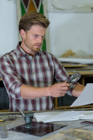 side view portrait of jeweler inspecting something