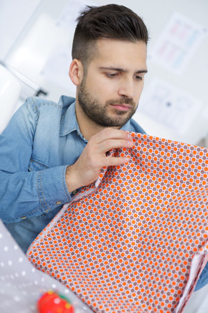 young man with a kitchen towelの写真素材