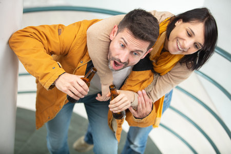 drunk couple stumble up staircase