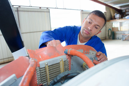 a mechanic working on aircraftの写真素材