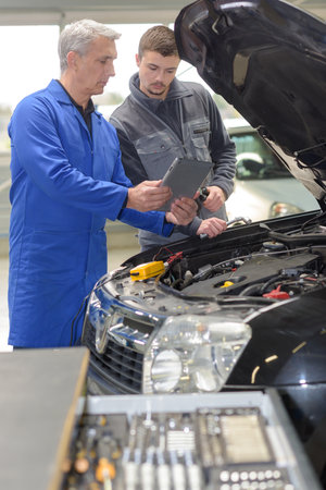 student repairing car in automotive vocational schoolの写真素材