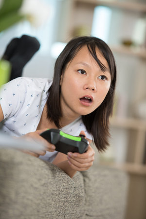 excited woman playing console video game