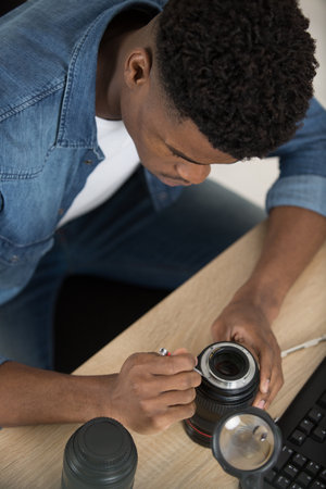 man disassembled lens mount slr cameraの写真素材