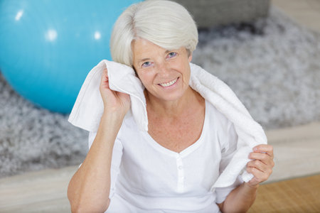 senior woman using a towel after sportの写真素材