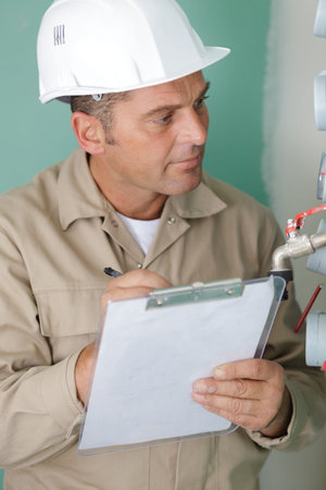 close up of a repairman working on pipes