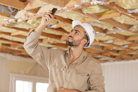 portrait of a builder taking a picture indoorsの写真素材