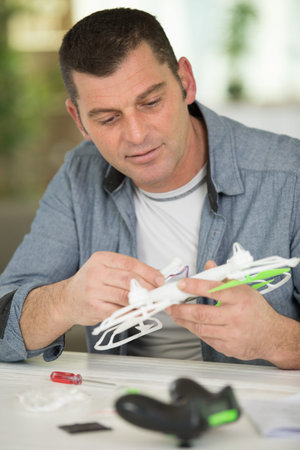 handsome man repairing drone
