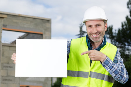 happy worker presenting empty bannerの写真素材