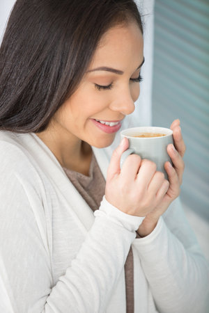 attractive woman waking up with the smells of coffeeの写真素材