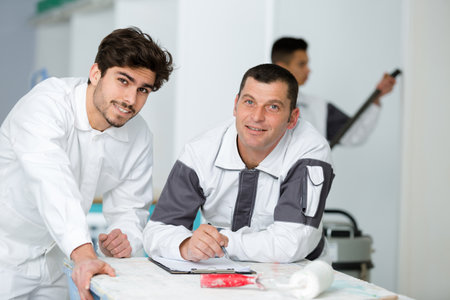 happy male house painters at workerの写真素材