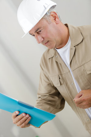 an engineer looking at folderの写真素材