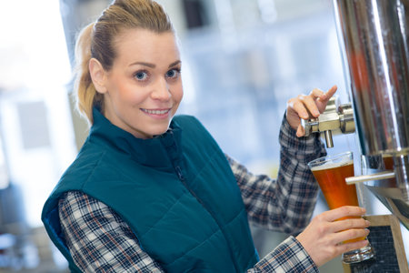 pretty female brewery worker on factoryの写真素材
