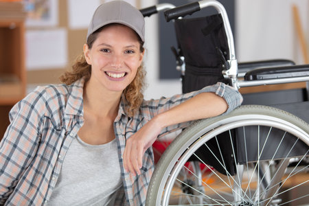 beautiful woman tradesman maintaining wheelchairの写真素材