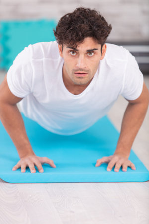 man doing plank exercise at home