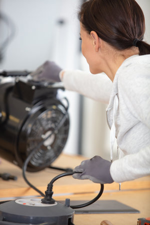 a woman looks at the electrical deviceの写真素材
