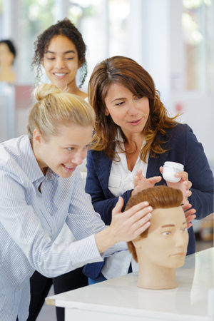 master learns on a dummy in a hairdresserの写真素材