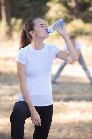 Exercising woman drinking waterの写真素材