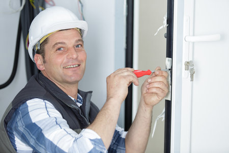 happy builder installing a windowの写真素材