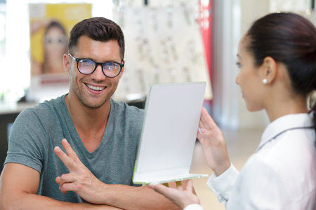 male optical customer smiling for the cameraの写真素材