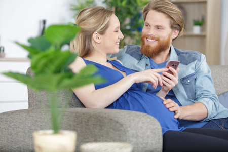 couple man and woman using the phoneの写真素材