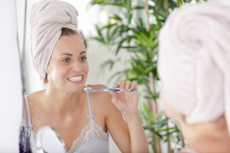 young woman brushing her teethの写真素材