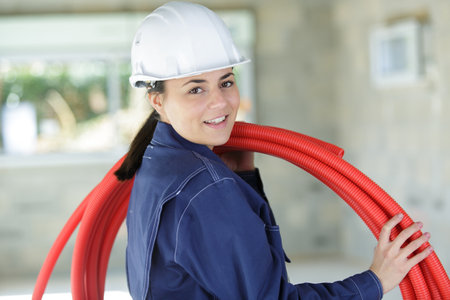 a woman fixing kitchen pipesの写真素材