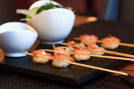 Shrimp on skewers with saladの写真素材