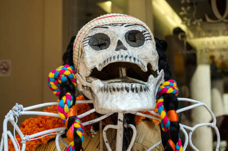 OAXACA, OAXACA, MEXICO- OCTOBER 30, 2017: Skull dressed with traditional clothes as decoration for mexican Day of the Dead celebration in Oaxaca, Mexicoのeditorial素材