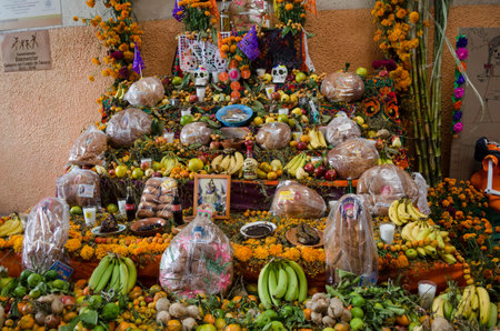 OAXACA, OAXACA, MEXICO- OCTOBER 30, 2017: Traditional offering altar with flowers, fruits, religious...