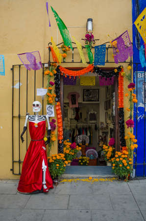OAXACA, OAXACA, MEXICO- OCTOBER 30, 2017: Skull dressed with a red dress outside of a store as decoration for mexican Day of the Dead celebration in Oaxaca, Mexicoのeditorial素材