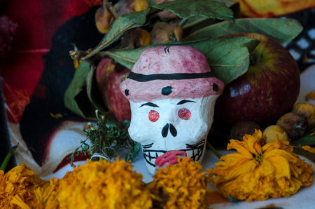 OAXACA, OAXACA, MEXICO- NOVEMBER 2, 2017: Skull with cempoalxochitl flowers and apples as part of an...