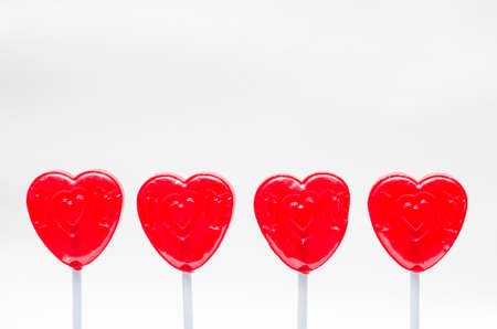 Four red lollipops against white background. Valentine's Day celebrationの写真素材