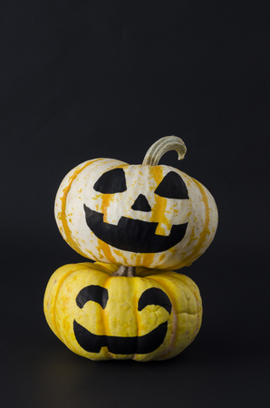 Cute Halloween pumpkins with happy expression against black background. Halloween pumpkin heads with smiles on black backgroundの写真素材