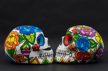 Hand painted  skulls with flowers against black background. Hand painted skulls for Halloween and...