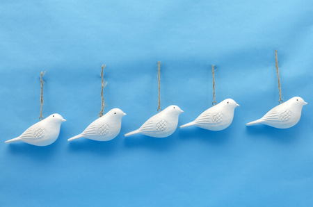 Wooden white doves against blue background. Christmas decoration. Christmas ornamentsの写真素材