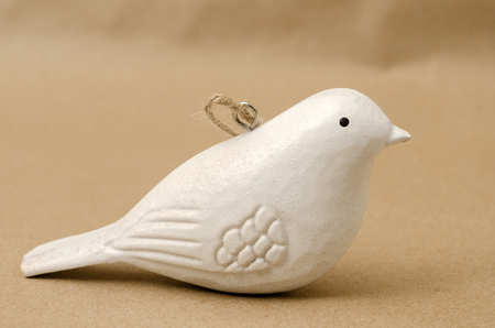 Wooden white dove against brown background. Christmas decoration. Christmas ornamentの写真素材