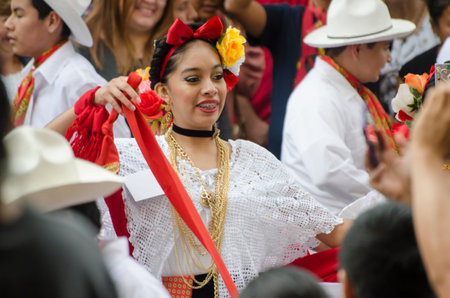 XALAPA, VERACRUZ, MEXICO- NOVEMBER 18, 2018: Young woman dressed with traditional clothes dancing at...