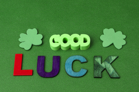 Saint Patrick's Day decoration. Good luck made from colorful letters and clovers on green backgroundの写真素材