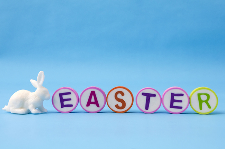 Easter made from colorful letters and white little bunny on blue background. Easter decorationの写真素材