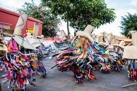OAXACA, OAXACA, MEXICO- JULY 6, 2019: Men dressed as tiliches, traditional costume from Putla,...