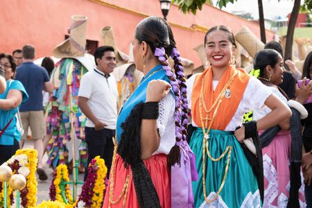 OAXACA, OAXACA, MEXICO- JULY 6, 2019: Young women dressed with traditional clothes during the Convite, a party made for invite to a big traditional party called Guelaguetza in Oaxaca, Mexicoのeditorial素材