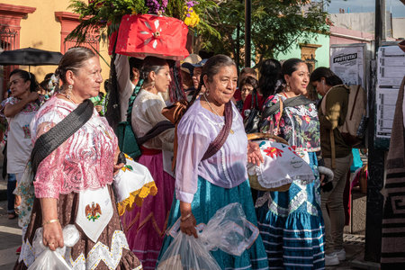OAXACA, OAXACA, MEXICO- JULY 6, 2019: Women dressed with traditional clothes during the Convite, a party made for invite to a big traditional party called Guelaguetza in Oaxaca, Mexicoのeditorial素材