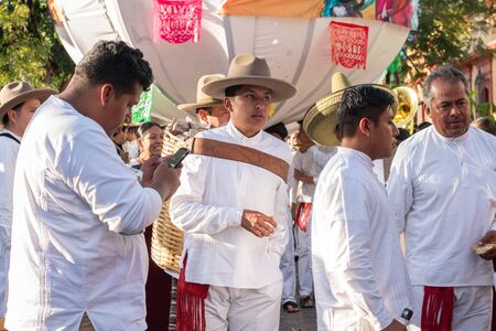 OAXACA, OAXACA, MEXICO- JULY 6, 2019: Young man carrying a basket during the Convite, a party made for invite to a big traditional party called Guelaguetza in Oaxaca, Mexicoのeditorial素材