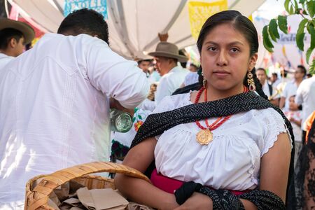 OAXACA, OAXACA, MEXICO- JULY 6, 2019: Young woman dressed with traditional clothes during the Convite, a party made for invite to a big traditional party called Guelaguetza in Oaxaca, Mexicoのeditorial素材